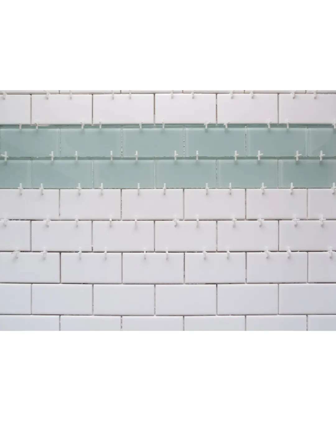 Tile spacers used in wall tiling for even spacing and straight grout lines